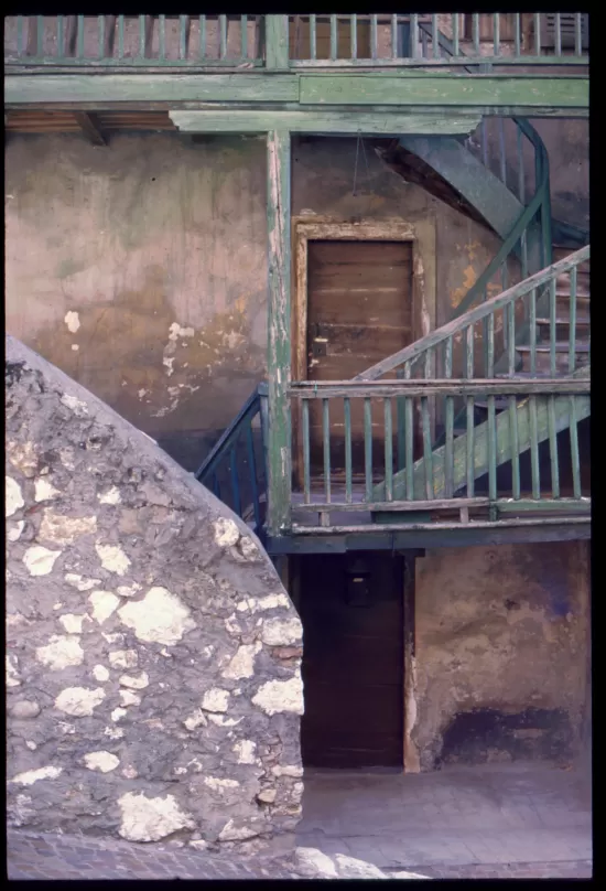 Exterior stair with faded, green paint