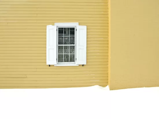 White window in yellow wall