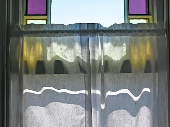 Stained glass window and cafe curtain