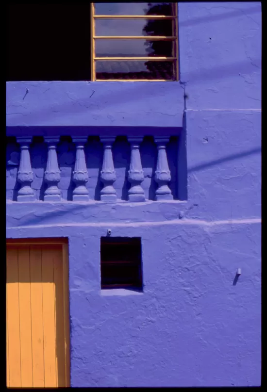 Masonry wall painted deep blue with yellow door