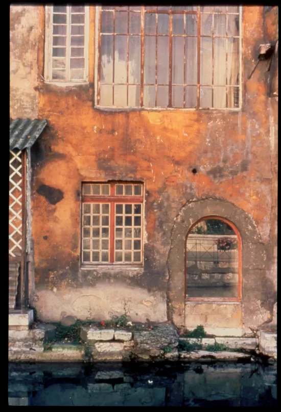 Old stucco wall with shuttered openings