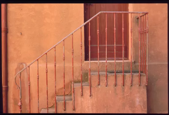 Iron stair railing on stucco building