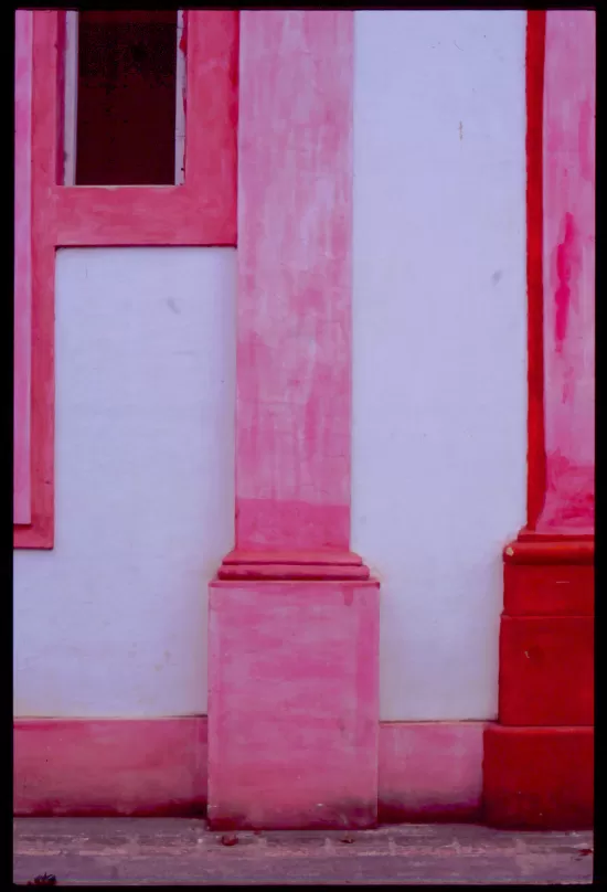 White wall with pink pilasters and trim