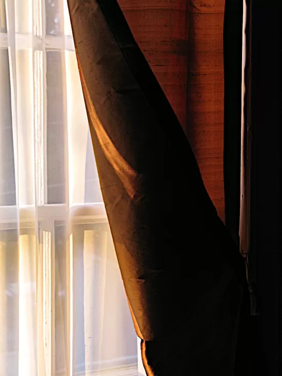 Window with sheer curtain and heavy drape