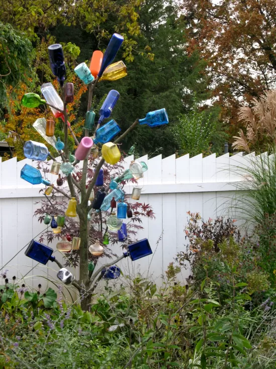 Tree decorated with colored glass bottles