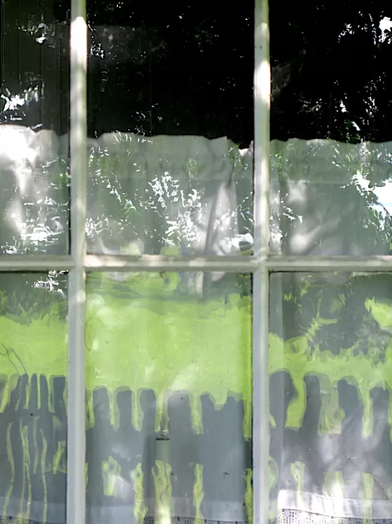 Fence reflected in window