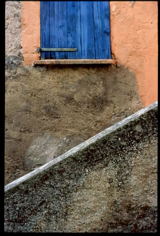 Blue shutters closed over window
