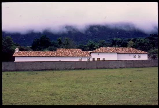 Low clouds hang over building with tile roof