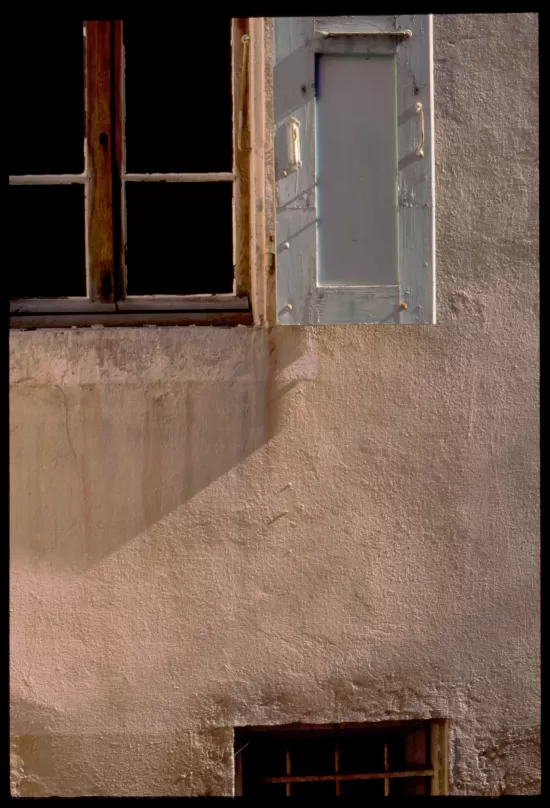 Stucco wall with shuttered window